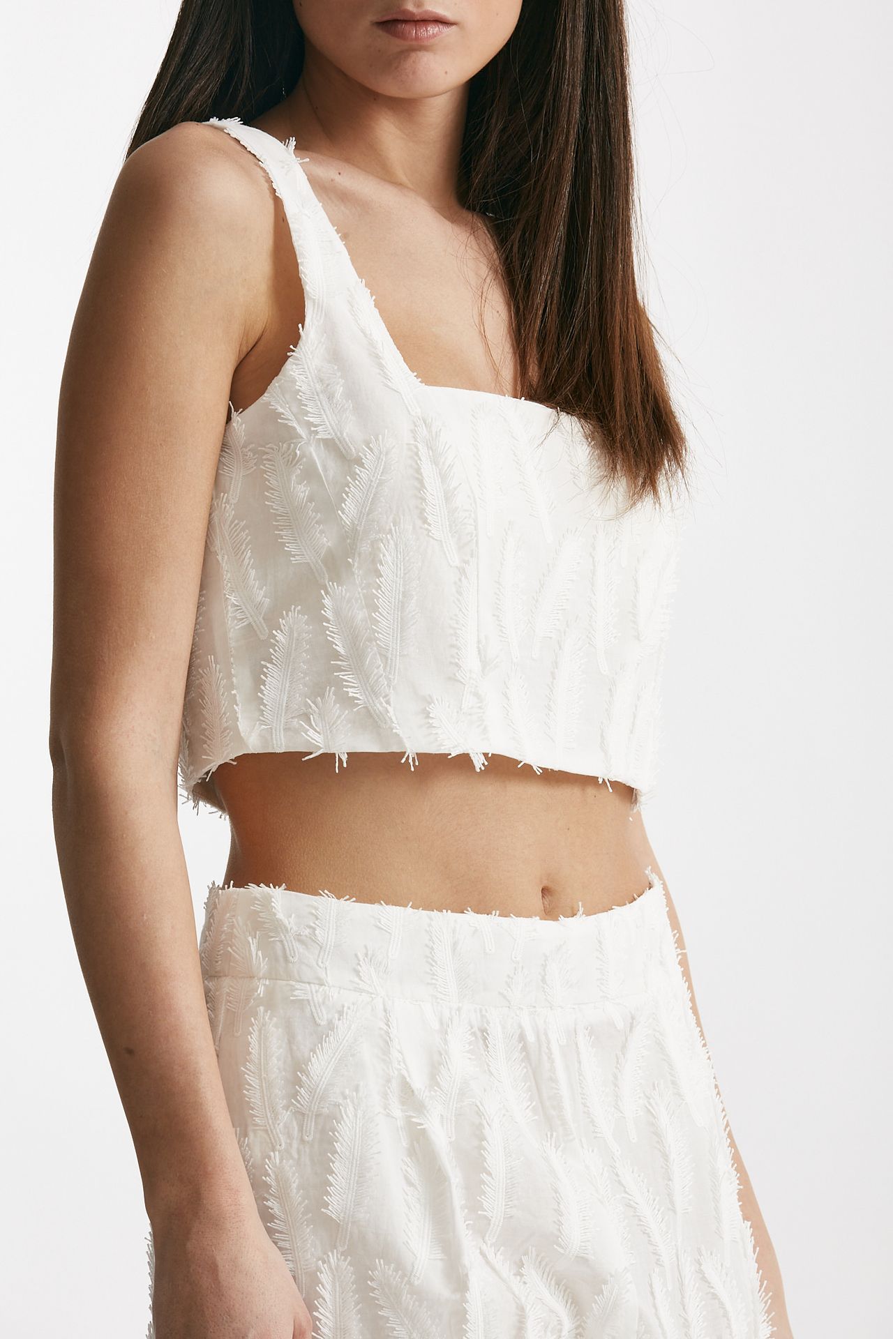 Top crop con applicazioni bianco